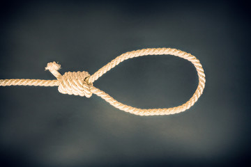 Noose on black background. Suicide concept. Hanging because of work stress. Depression of burnout. Terrible life situation.