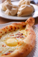 Khachapuri Adzharsky close-up and khinkali.