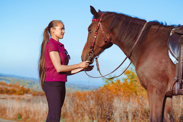 Obraz premium young beautiful girl strokes horse