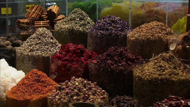 Close-up low angle still shot of a variety of dried spices on display at a market, Dubai Souk, UAE