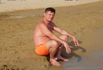 man in the sea on the beach in Bibione, Italy