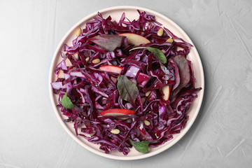 Fresh red cabbage salad served on light grey table, top view