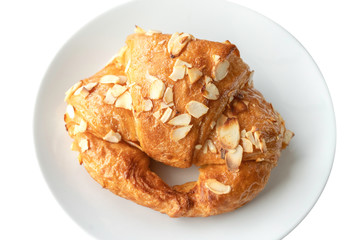 Almond cream croissant in white plate on isolated white background.