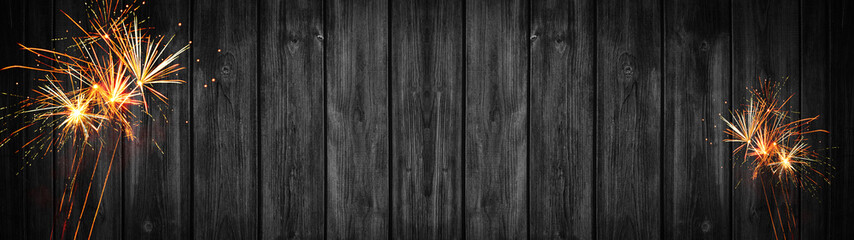 Silvester new year party 2020 panorama banner long, fireworks on rustic dark black wooden texture, with space for text