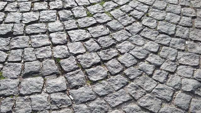 Slow motion footage of a cobble road.