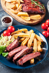 Spicy barbecued pork ribs served with french fries