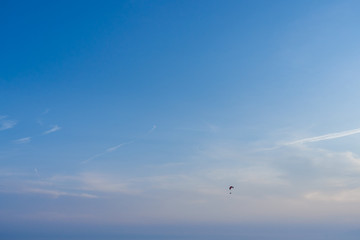 Extreme flight with parachute in sky. Horizontal color photography.
