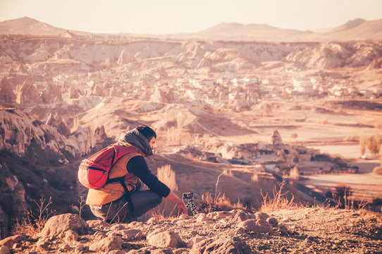 Traveler taking photos of panoramic view in Cappadocia