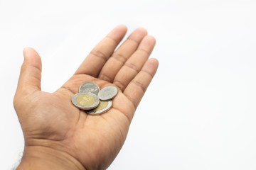 Closeup of coins on man hand on white background and copy space for text. Business, Money and savings concept.