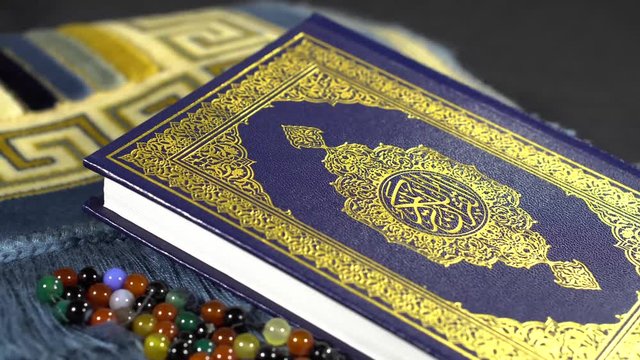 Rotating Revolving Quran Kareem Muslims Holy Book Shot of Quran with colorful tasbeeh Paternoster - 4K