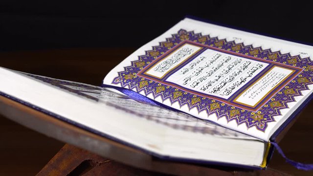 Rotating Revolving shot of Holy Quran Muslims Holy Book Quran Kareem Surah Fatiha Starting Arabic Text of Quran - 4K