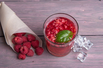 Glass of fresh strawberry summer cocktail and strawberries on the wooden background. Healthy food...