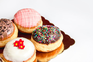 Group of fresh decorated doughtnuts on one plate