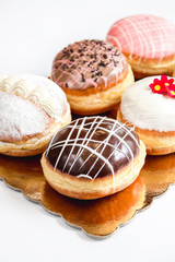 Group of fresh decorated doughtnuts on one plate
