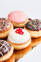 Group of fresh decorated doughtnuts on one plate