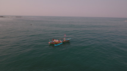 fishermen and small boats heading for the ocean