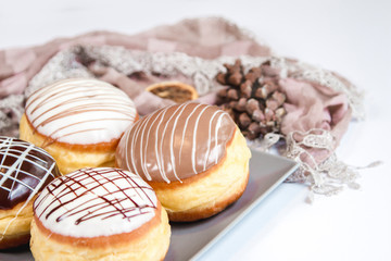 Group of fresh decorated doughtnuts on one plate