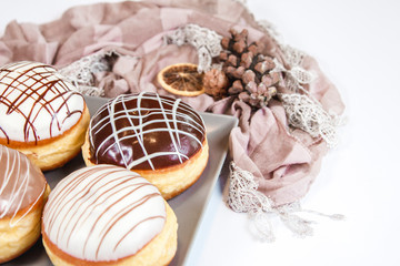 Group of fresh decorated doughtnuts on one plate