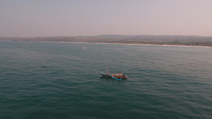 small boat in the middle of the ocean