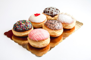 Group of fresh decorated doughtnuts on one plate
