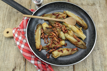 braised endives with bacon in a dish