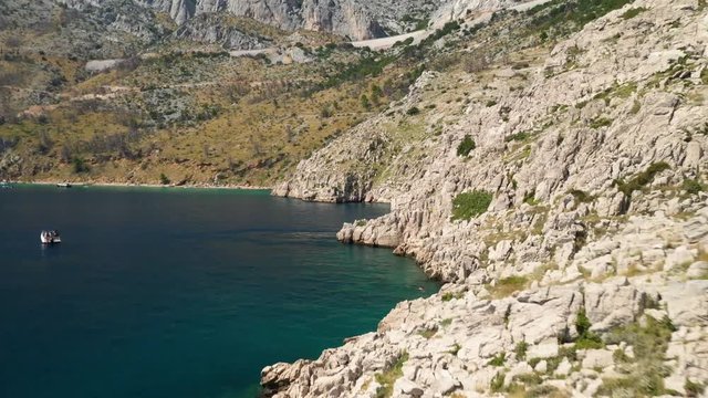 Aerial drone footage. Flying above and following the coastline with the camera pointed forward..