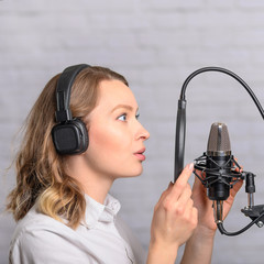 Recording speech on radio stations, the announcer works in the studio with a studio microphone....
