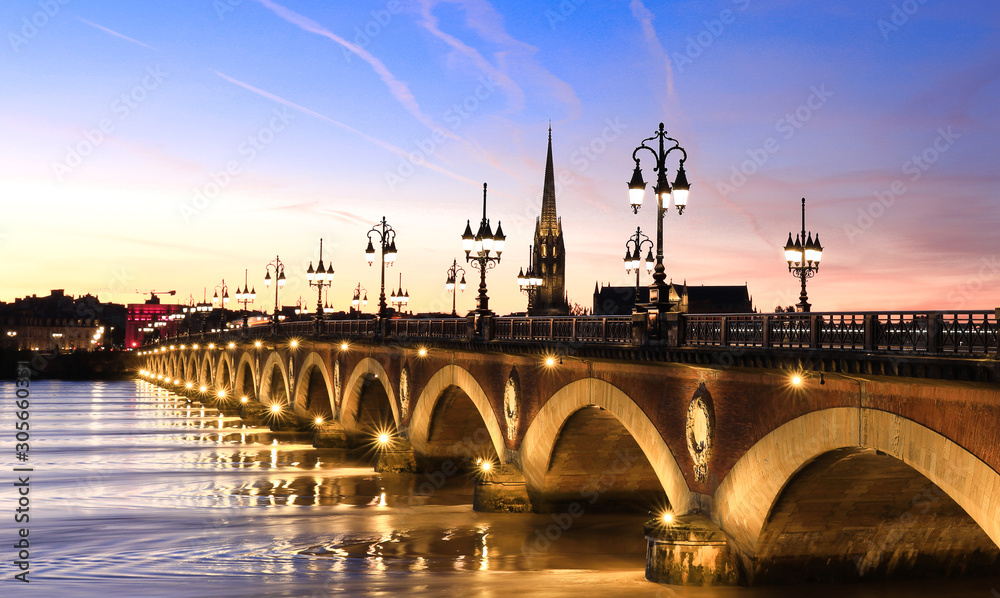 Wall mural view of the pont de pierre with sunset sky scene which the pont de pierre crossing garonne river