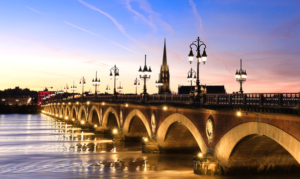 View of the Pont de pierre  with sunset sky scene which  The Pont de pierre crossing Garonne river 