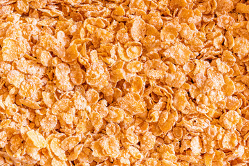Frosted Corn Flakes closeup background. A sugary breakfast favorite.