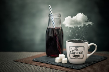 Fresh berry juice and creamy coffee with surreal snowing cloud on a rustic table and backgrounds