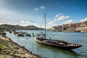 Fototapeta premium Porto, Portugal old town cityscape on the Douro River with traditional Rabelo boats. 