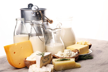 Different  healthy dairy products on rustic background with milk, cheese, butter and cottage