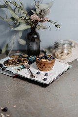 Flakes with blueberries and raspberries in wooden plates