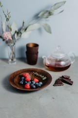 Blueberries and raspberries in a wooden plate