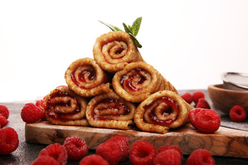 Delicious Tasty Homemade crepes or pancakes with raspberries and mint on rustic background