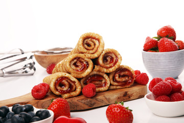 Delicious Tasty Homemade crepes or pancakes with raspberries and mint on rustic background
