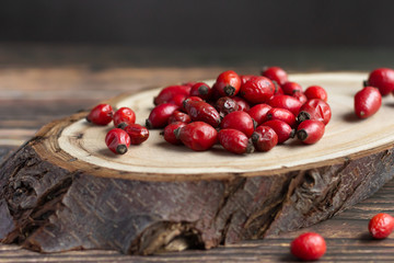Rosehip fruits on wood, rich in vitamin C, immunity protection and antioxidant