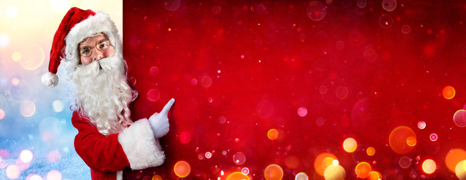 Santa Claus Pointing With Finger On Red Billboard