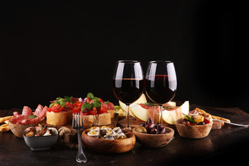 Italian antipasti wine snacks set. Cheese variety, Mediterranean olives, seafood salad, Prosciutto...