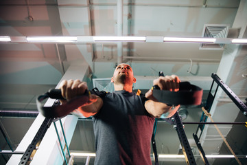 The young sports guy is engaged in fitness, lifestyle, sports and healthy eating, in the gym a man is doing exercises