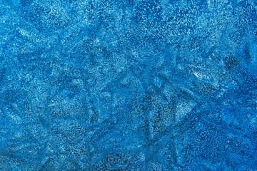 blue decorative plaster background , stucco wall with copyspace , color abstraction , wallpaper close up , azure ice macro , frozen winter texture