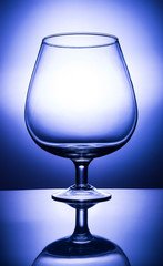 empty wine glass on blue background