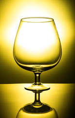empty wine glass on yelow background
