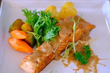 fried fish with salad and lemon
