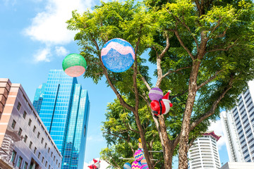 Christmas ornaments and Santa Claus mysteriously floating in the air along public streets