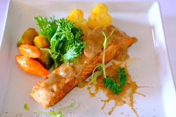 Grilled salmon steak with sauce
