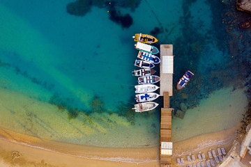 Aerial of a peer with boats and blue ocean water