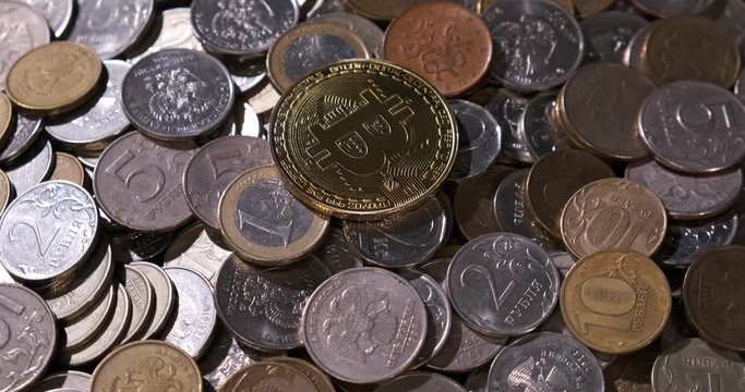 Golden bitcoin lies on pile of little things, iron money, spinning composition, pile of small money, winner in battle between two economic systems, golden symbol of digital economy, penny, cripto, btc