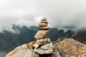 stack of stones on background of blue sky and clouds